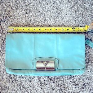 Teal coach clutch, silver accents, pristine interior, no outside flaws